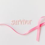 survivor pink ribbon next text symbolizing breast cancer awareness hope