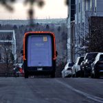 amazon delivery van driving through kentsel sokak twilight cars parked along