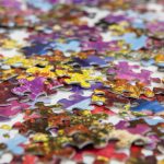 jigsaw vibrant close up scattered puzzle pieces white surface showcasing variety colors
