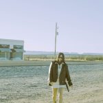 prada kadin walking near iconic marfa installation valentine texas desert
