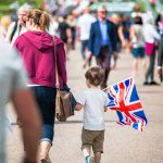 prince harry selective focus photography boy holding u k bayrak walking pathway full
